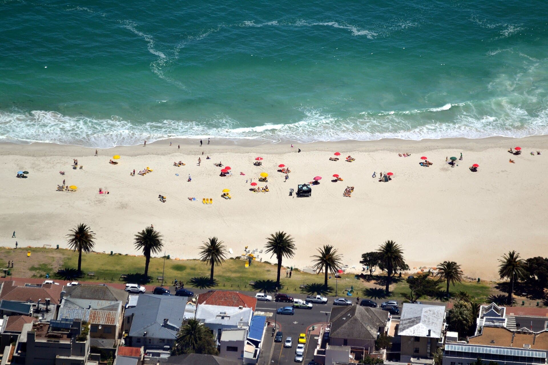 Camps Bay beach from Table Mountain — white sand, palms and teal Atlantic surf below Cape Town